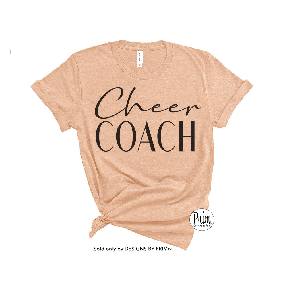 Designs by Prim Cheer Coach Soft Unisex T-Shirt | Cheerleader Cheerleading Squad Fitness Instructor High School Football Training Pom Pom Dance Top