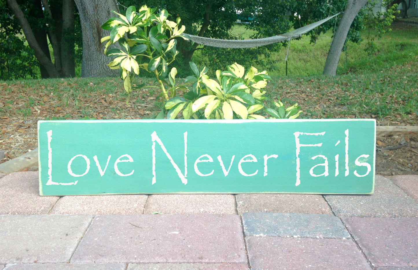 18x4 Love Never Fails Wood Family Sign